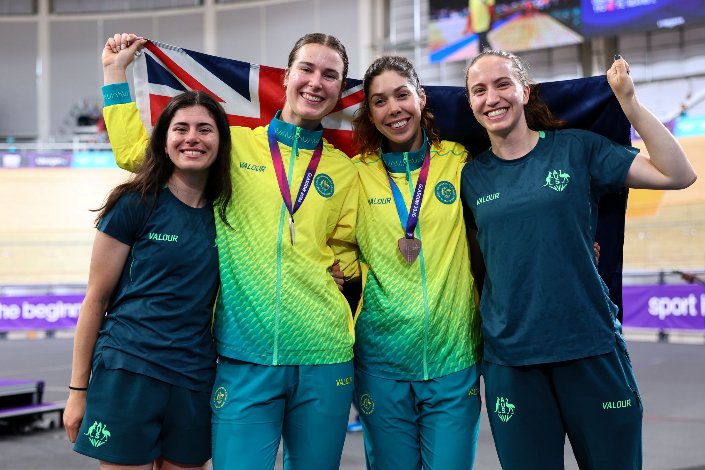 Claudia Marcks and Georgia Baker of Australia pose with medals alongside Alyssa Polites and Sophie Edwards at the Glasgow 2026 Commonwealth Games.